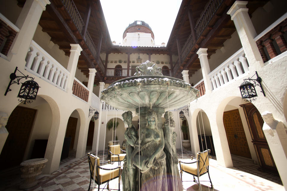 Water flows from a fountain at the Versace mansion in Miami Beach, Fla. on Tuesday, July 23, 2013. Though the Versace family hasn't owned the oceanfront mansion since 2000, auctioneers hope the Italian designer's legacy will attract bidders to the Miami Beach property when it goes up for auction Sept. 17. Gianni Versace was fatally shot on the mansion's stone front steps in 1997 by serial killer Andrew Cunanan. (AP Photo/J Pat Carter)