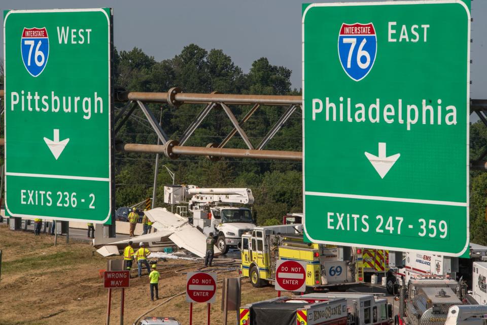 Emergency crews respond to a plane that crashed into a bucket truck just west of the toll plaza on the Pennsylvania Turnpike near I-83 May 3, 2023.