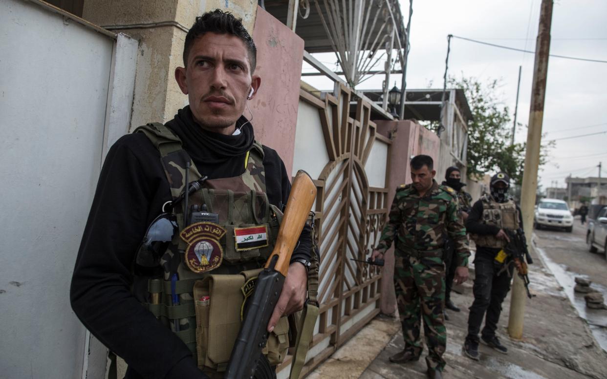 Members of the Iraqi National Security Service arrest a young man they suspect of being affiliated with ISIS  - Sam Tarling