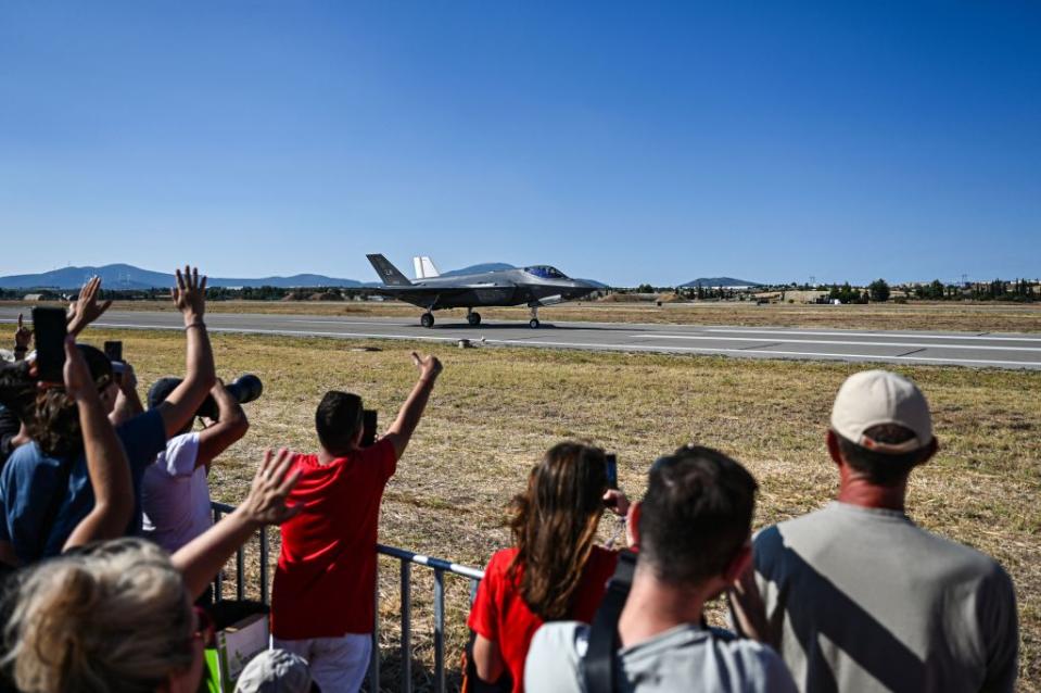 Spectators cheer as they look at the F-35A stealth fighter jet of the F-35A Demo team of the United States Air Force during the aviation event 11th Athens Flying Week over Tanagra air base in Schimatari, north of Athens, on September 3, 2023. (Photo by Theophile Bloudanis / AFP) (Photo by THEOPHILE BLOUDANIS/AFP via Getty Images)