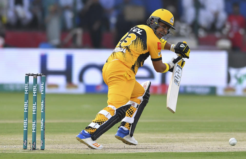 Kamran Akmal of Peshawar Zalmi hits a boundary against Karachi Kings in the Pakistan Super League match at the National Stadium in Karachi, Pakistan, Friday, Feb. 21, 2020. (AP Photo/Fareed Khan)