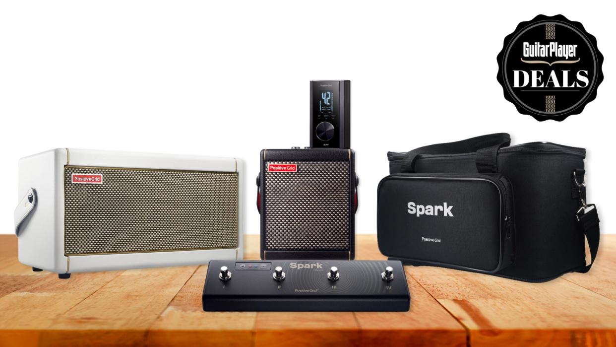  A selection of Positive Grid smart amps and accessories on a wooden desk. 