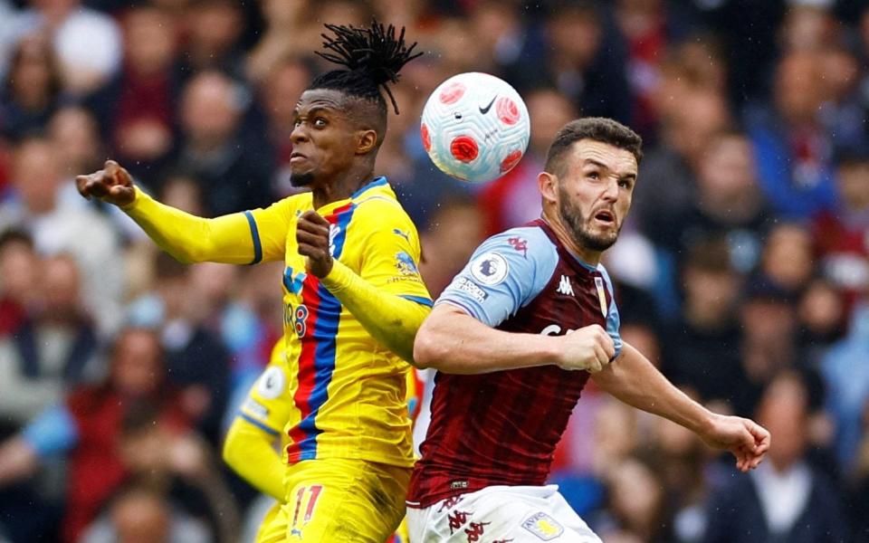 Aston Villa's John McGinn in action with Crystal Palace's Wilfried Zaha - ACTION IMAGES