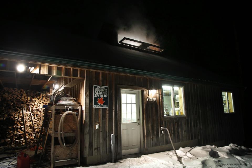 In this March 13, 2014 photo, steam rises from a roof window of the Turtle Lane Maple sugar house in North Andover, Mass. Maple syrup season is finally under way in Massachusetts after getting off to a slow start because of unusually cold weather. (AP Photo/Elise Amendola)