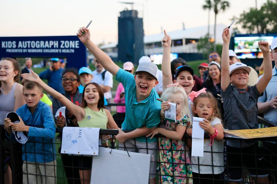 Kids cheer as Jordan Spieth walks their way to sign autographs after the first round of the 2023 tournament.