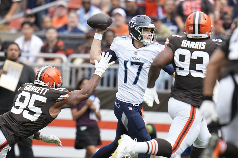 Tennessee Titans quarterback Ryan Tannehill (17) throws a pass as he is pressured by Cleveland Browns defensive end Myles Garrett (95) and defensive tackle Shelby Harris (93) during the first half of an NFL football game Sunday, Sept. 24, 2023, in Cleveland. (AP Photo/Sue Ogrocki)