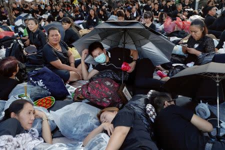 Mourners wait for tomorrow's Royal Cremation ceremony of Thailand's late King Bhumibol Adulyadej at the Grand Palace in Bangkok. REUTERS/Damir Sagolj