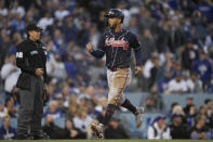 Atlanta Braves' Eddie Rosario runs across home plate after scoring on an RBI single by Joc Pederson during the third inning against the Los Angeles Dodgers in Game 4 of baseball's National League Championship Series Wednesday, Oct. 20, 2021, in Los Angeles. (AP Photo/Ashley Landis)