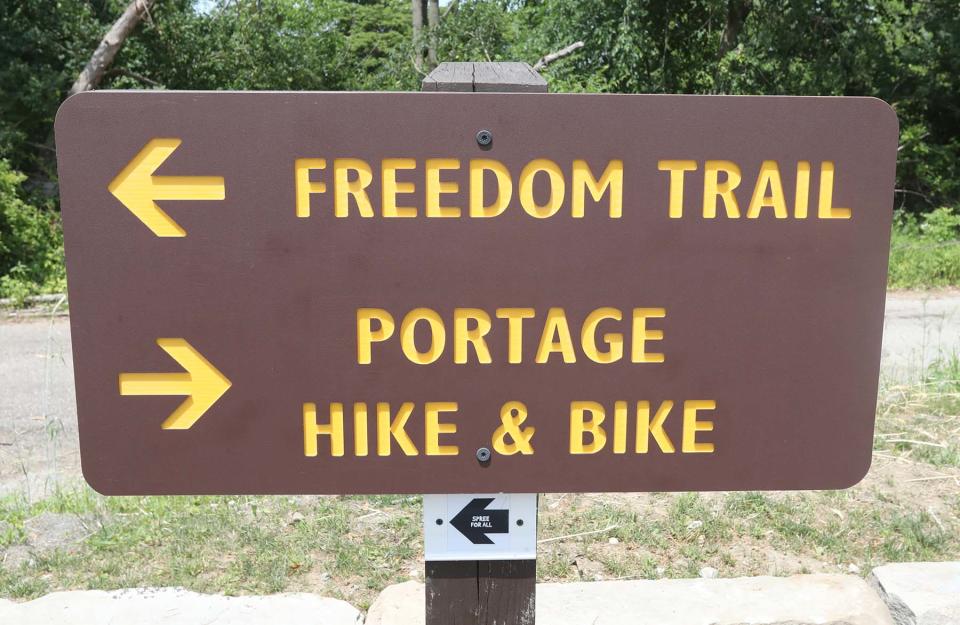 A directional sign at the Middlebury Road Trailhead points the way for users of the Freedom Trail on Saturday in Tallmadge.