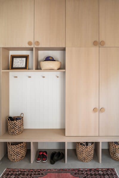 The entryway has enough storage for the family of four, with spots for guests.
