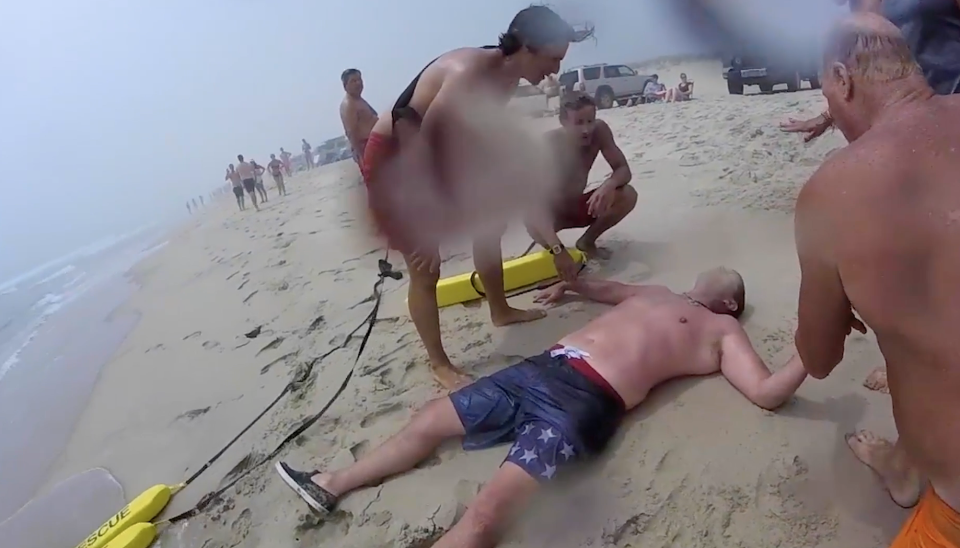 NANTUCKET --  This screen capture from the documentary "Rip Current Rescue" shows an exhausted Derrick Johns lying on the sand after he was rescued from a rip current at Surfside Beach in July 2015.