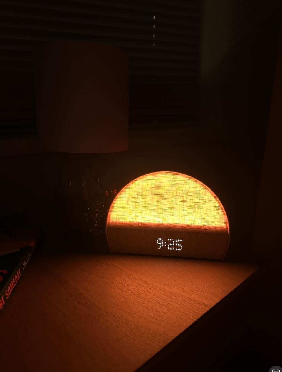 Sunrise alarm clock displaying 9:36 in a dimly lit room