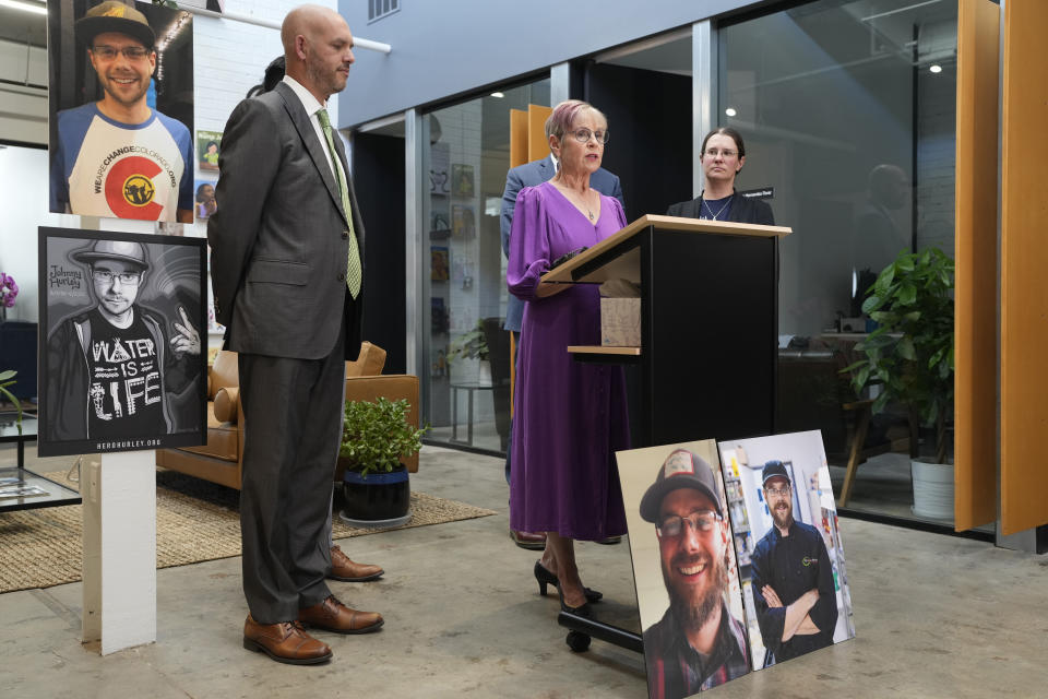 Kathleen Boleyn, center, mother of man who was fatally shot by a police officer from the Arvada, Colo., Police Department in June 2021, talks about the $2.77-million settlement reached with the northwest Denver suburban city Thursday, Sept. 28, 2023, in Denver. Boleyn's son, Johnny Hurley, was shot after he had killed an active shooter who had killed an Arvada officer in the city's Olde Town area on June 21, 2021. Attorney Matthew J. Cron, left, and Boleyn's daughter, Erin Hurley, look on during the news conference to announce the settlement. (AP Photo/David Zalubowski)