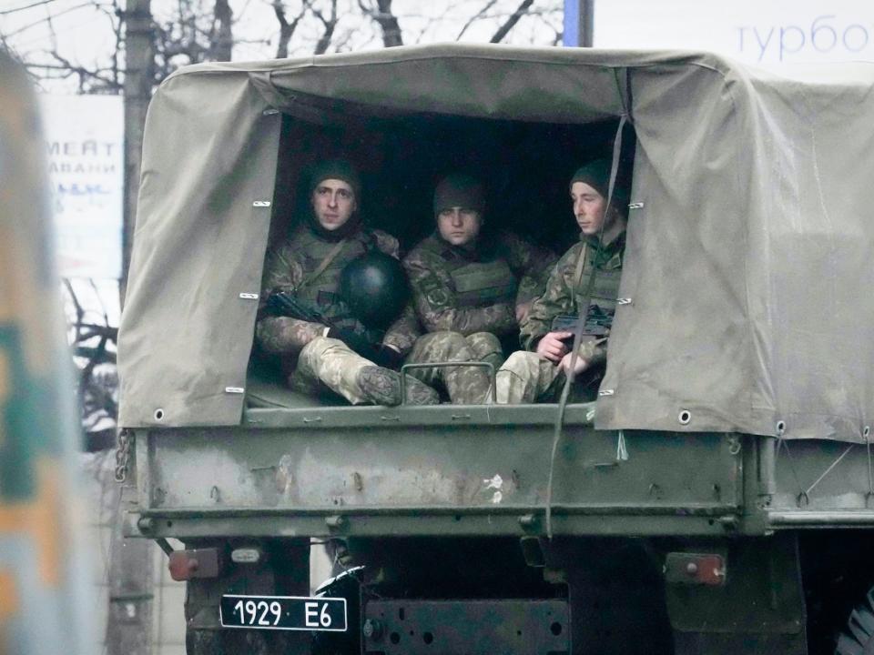 Ukrainian soldiers ride in a military vehicle