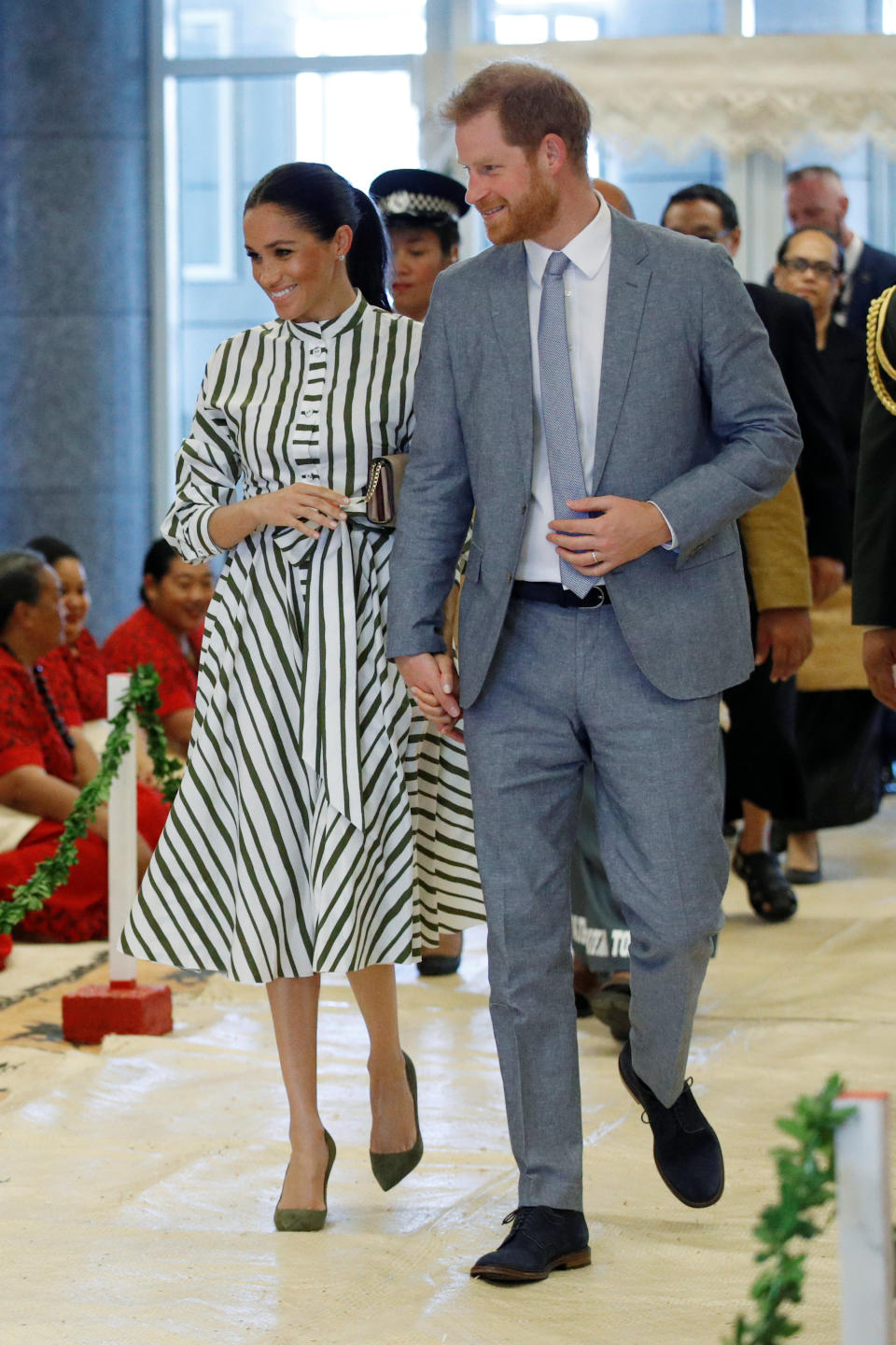 <p>For the couple’s second day in Tonga, the Duchess chose a striped midi dress by Martin Grant – a label she has looked to throughout the tour so far. She accessorised the daytime look with a Prada clutch, stud earrings from Birks and olive green shoes. <em>[Photo: Getty]</em> </p>