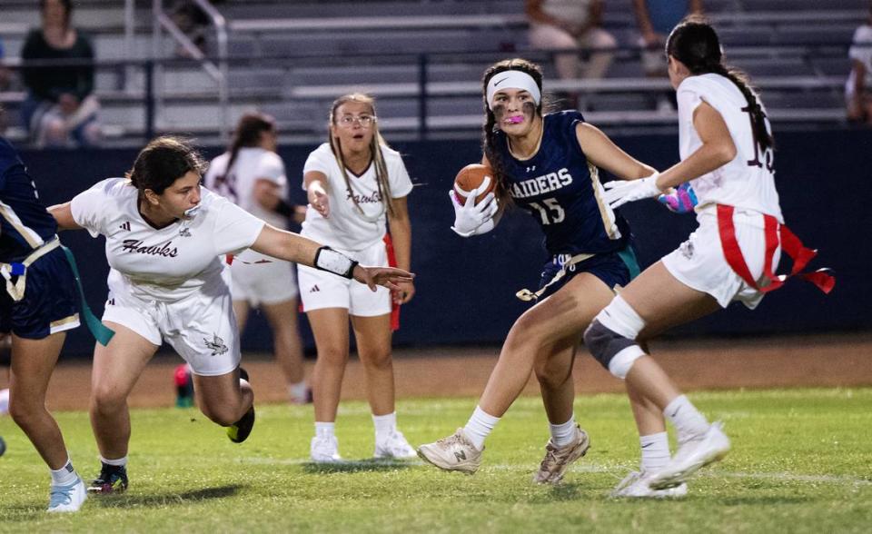 Central Catholic’s Stephanie Garcia (15) runs the ball during the flag football game between Central Valley and Central Catholic at Central Catholic High School in Modesto , Calif., Thursday, August 24, 2023. Central Catholic won the game 34-14.