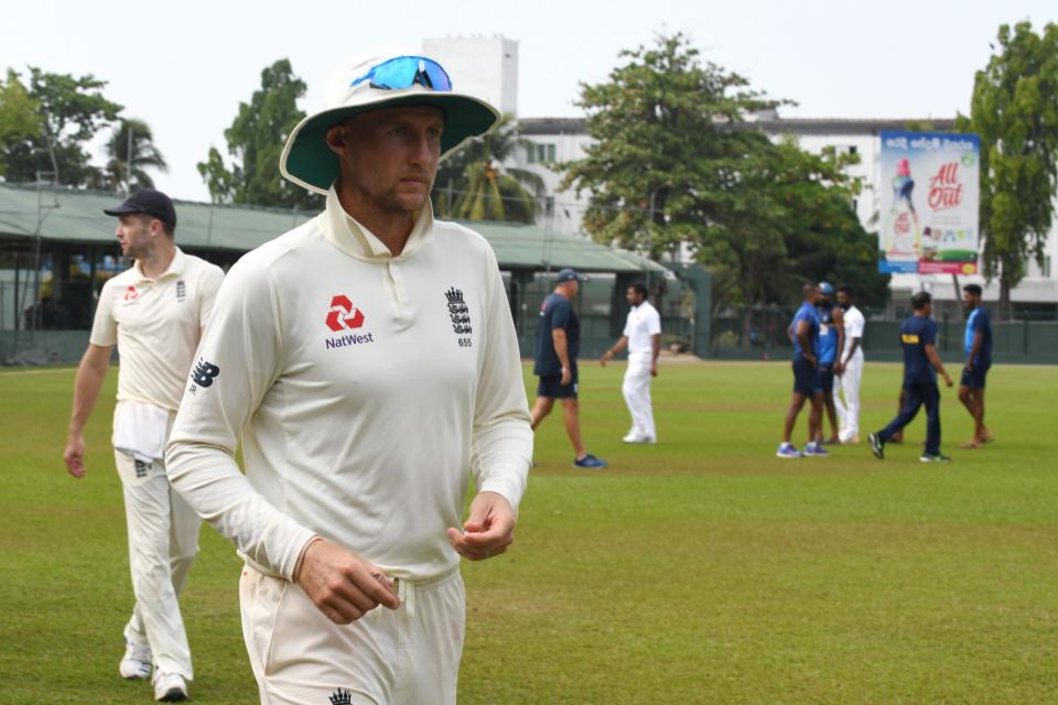 England captain Joe Root leads his team off the field after the tour of Sri Lanka was abandoned because of the outbreak (AFP via Getty Images)