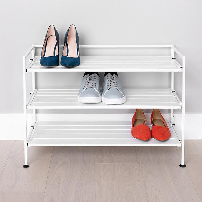 white three-tier shoe rack with flats, heels, and sneakers