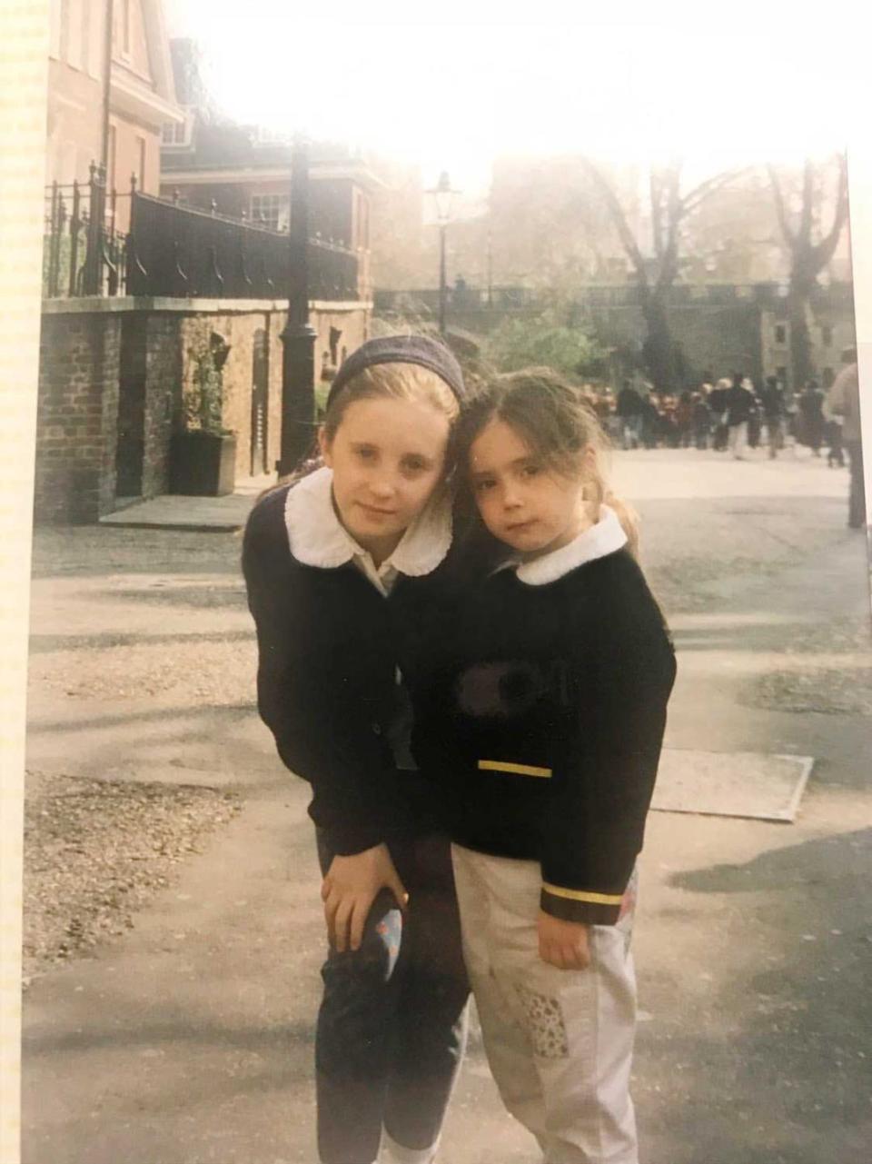 two young sisters pose for a family photo in london