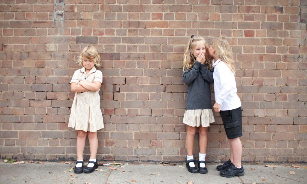 Bullying and whispering school kids in uniform