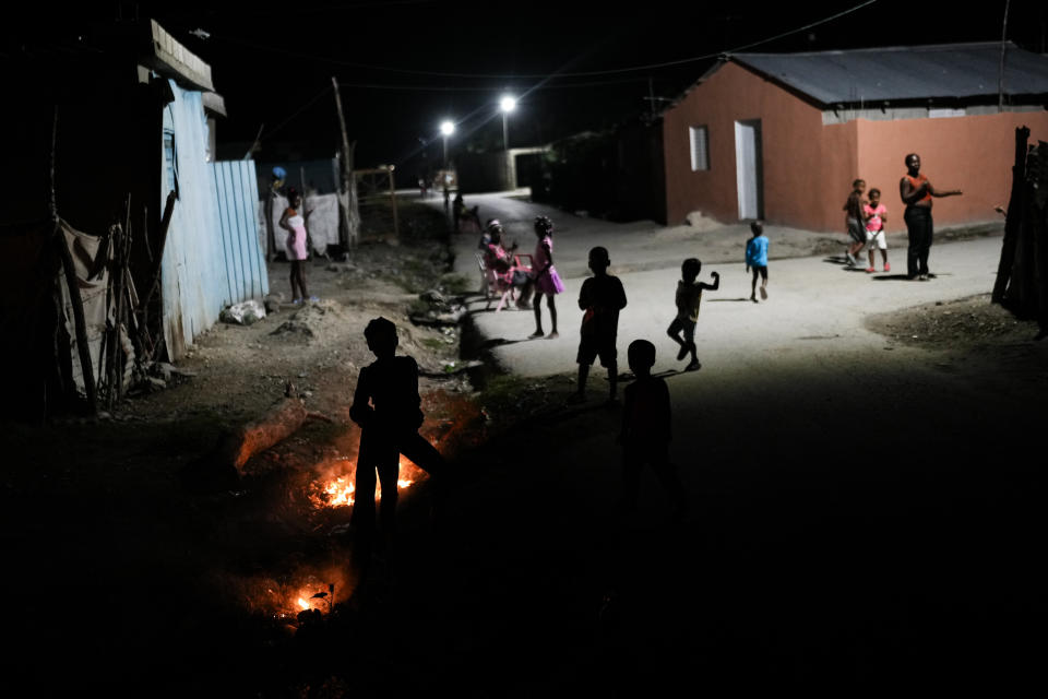 Haitians gather outdoors at the Five batey in the Bahoruco province, Dominican Republic, Wednesday evening, May 15, 2024. The Dominican Republic bateyes are settlements of mostly Haitian immigrants and descendents working in the nearby sugarcane plantations. (AP Photo/Matias Delacroix)