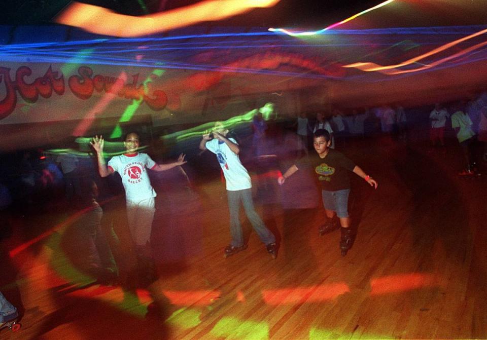 Kids take a whirl around the roller rink at Super Wheels in Kendall when it reopened in 2001.