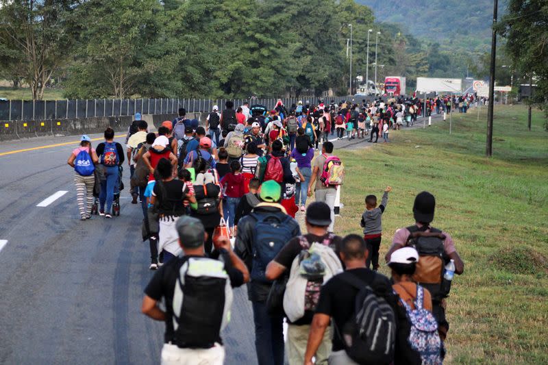 Migrants walk in a caravan to reach the U.S. border through Mexico, in Escuintla