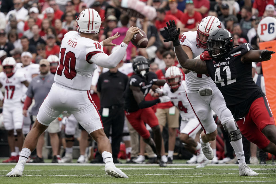 Cincinnati defensive lineman Malik Vann (42) pressures Miami (Ohio) quarterback AJ Mayer (10) during the first half of an NCAA college football game Saturday, Sept. 4, 2021, in Cincinnati. (AP Photo/Jeff Dean)