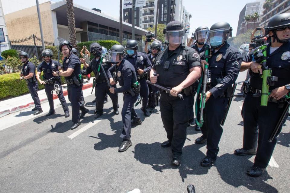 Police form a line as they prepare to confront the protest at Wi Spa on 3 July.