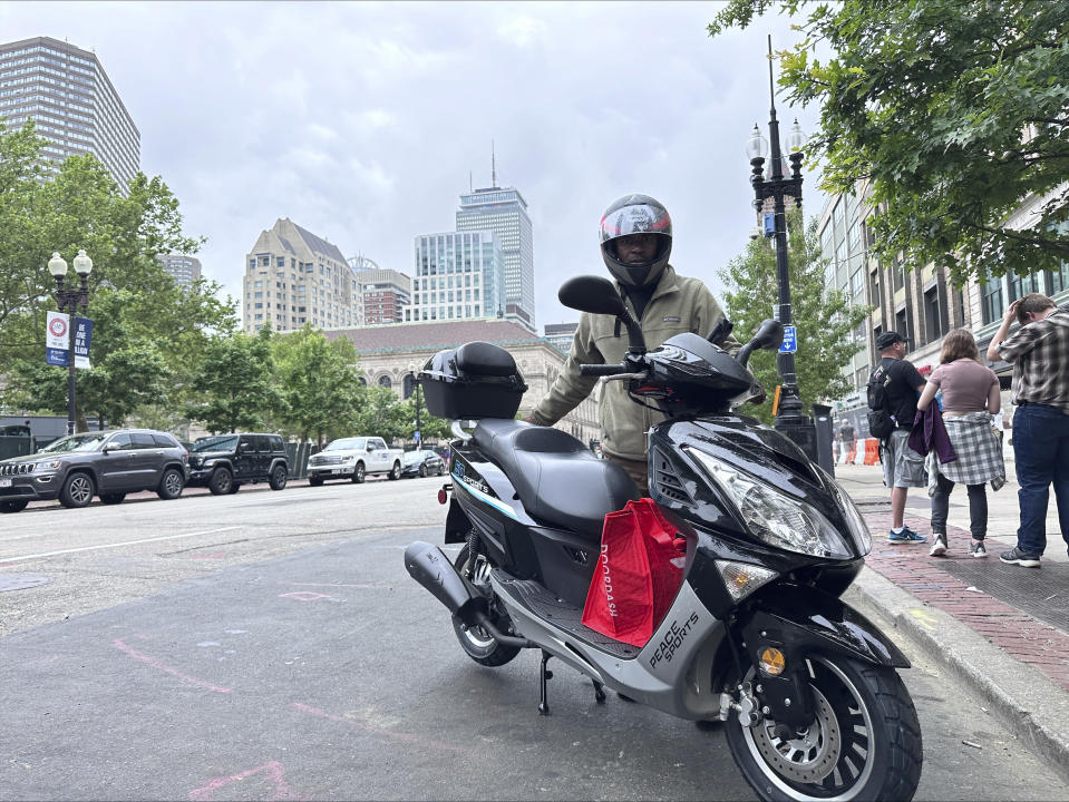 Delivery scooters are parked as drivers wait to pick up food for delivery, Thursday, June 6, 2024, in Boston. Boston and New York are cracking down on unlawful drivers, whom they say are ignoring traffic laws and making city streets more dangerous. (AP Photos/Michael Casey)