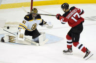 Boston Bruins goaltender Jaroslav Halak (41) makes a save on a shot by New Jersey Devils center Yegor Sharangovich (17) during the first period of an NHL hockey game, Tuesday, May 4, 2021, in Newark, N.J. (AP Photo/Kathy Willens)