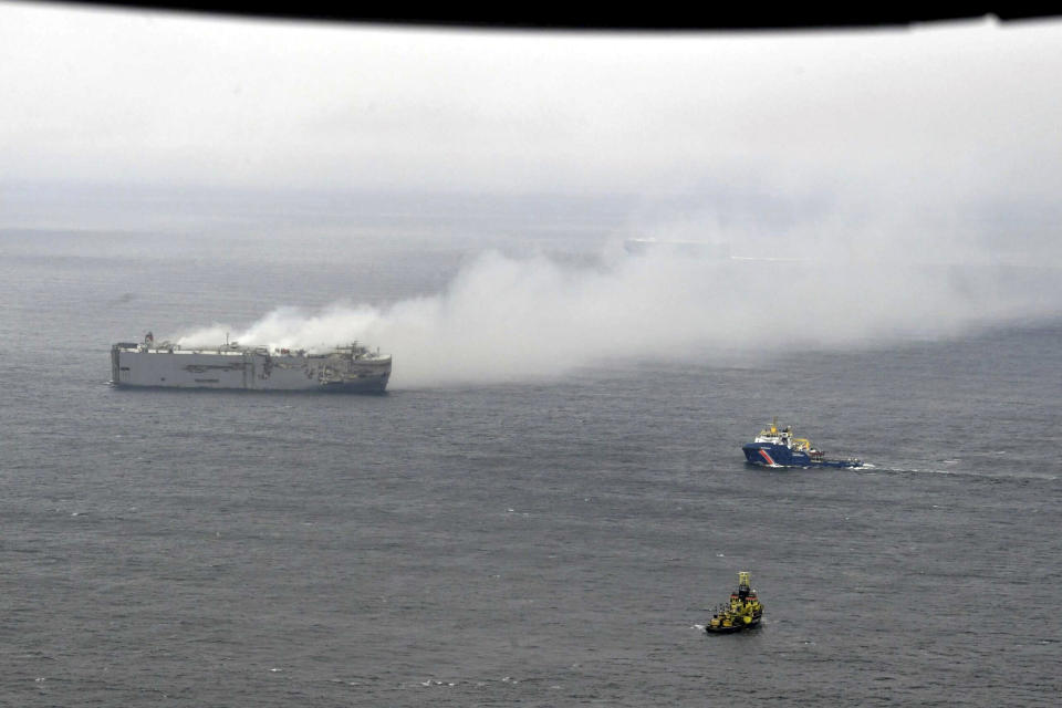 Smoke is seen from a freight ship in the North Sea, about 27 kilometers (17 miles) north of the Dutch island of Ameland, Thursday, July 27, 2023. A cargo ship packed with nearly 3,000 cars was still ablaze Thursday close to a world-renowned bird habitat off the Dutch coast as firefighters and salvage crews waited for the flames to subside before attempting to board the vessel. (Kustwacht Nederland/Coast Guard Netherlands via AP)