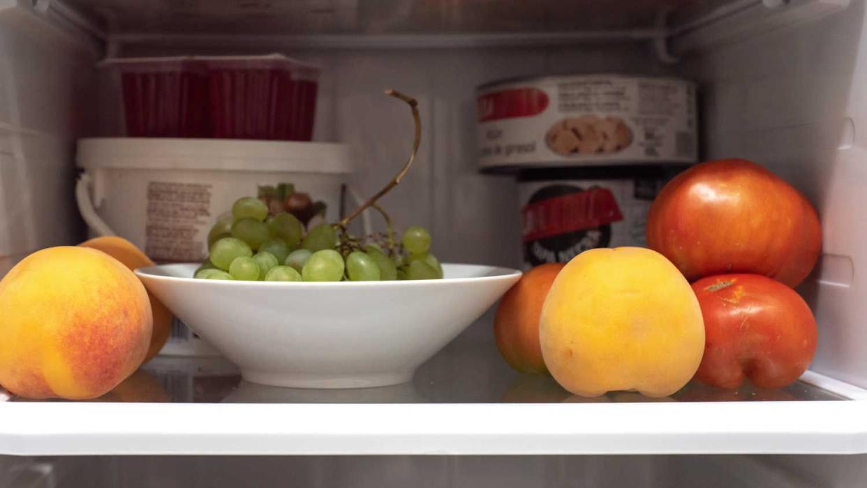 Open refrigerator full of fruits
