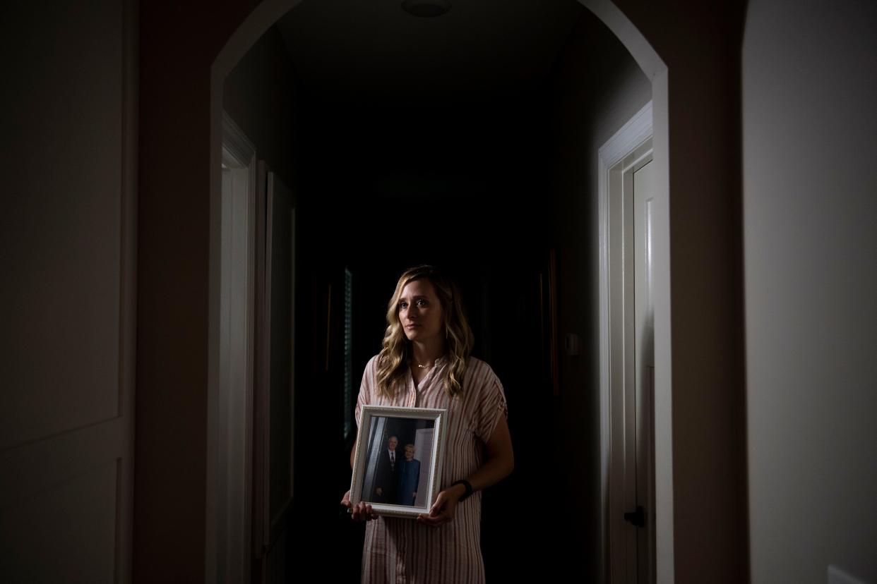 Ashley Helton Rutledge holds a photograph of her grandparents, Bill and Donna Helton, at her grandfather’s home in Lawrenceburg, Tenn., Friday, July 14, 2023.