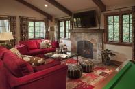 <p>Red sofas complement the rustic aesthetic of this space from <a href="https://deringhall.com/interior-designers/suzanne-childress-design" rel="nofollow noopener" target="_blank" data-ylk="slk:Suzanne Childress Design;elm:context_link;itc:0;sec:content-canvas" class="link ">Suzanne Childress Design</a>.</p>