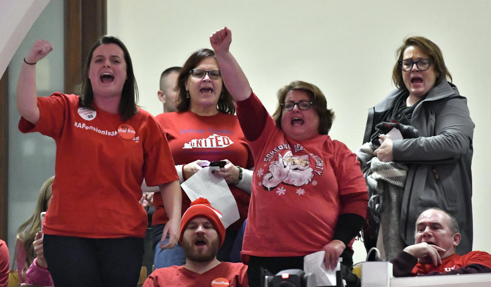 Protesters shout from the gallery overlooking the Kentucky house of representatives in protest of the special session at the Kentucky state Capitol in Frankfort, Ky., Monday, Dec. 17, 2018. Days after losing at the state Supreme Court, Kentucky's Republican governor called the legislature back in session Monday to try again to reshape the state's troubled public pension system. (AP Photo/Timothy D. Easley)