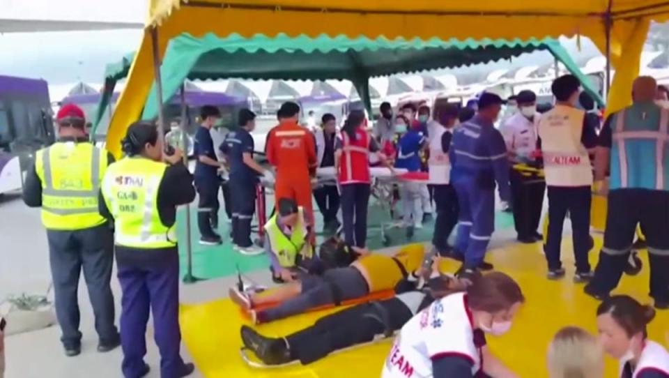 Injured passengers being treated on the airport tarmac in Bangkok after the London to Singapore flight hit severe turbulence and was forced to divert (Pongsakorn Rodphai)