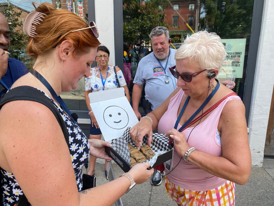 A guest on the Louisville Food Tour selects a Derby Bar during a stop at Please & Thank You in the NuLu neighborhood.