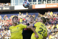 New York Red Bulls defender Sean Nealis, center, tries to head the ball with Nashville SC's Jack Maher, left, and Walker Zimmerman (25) in the first half of an MLS soccer match Sunday, Nov. 7, 2021, in Nashville, Tenn. (AP Photo/Mark Humphrey)