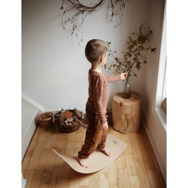 Child balancing on the wobble board