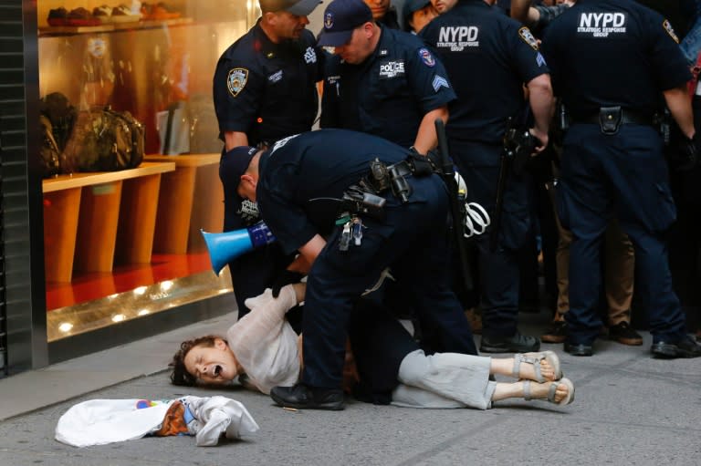 A woman is arrested by police near Trump Tower in New York during a protest against US President Donald Trump on August 14, 2017