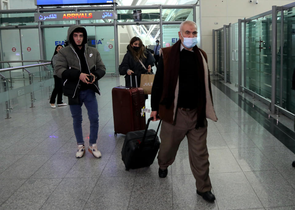 Iraqi migrants arrive to the airport in Irbil, Iraq, early Friday, Nov. 26, 2021. 170 Iraqi nationals returned home Friday from Belarus in a repatriation process that came after tensions at Poland's eastern border, where thousands of migrants became stuck in a cold and soggy forest. (AP Photo/Hussein Ibrahim)