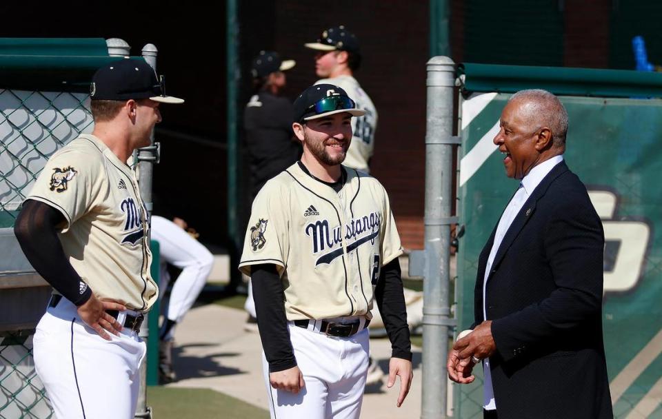 Ozzie Smith talks with Cal Poly baseball players after the re-dedication of his statue and plaza at Baggett Stadium in San Luis Obispo on March 25, 2023.