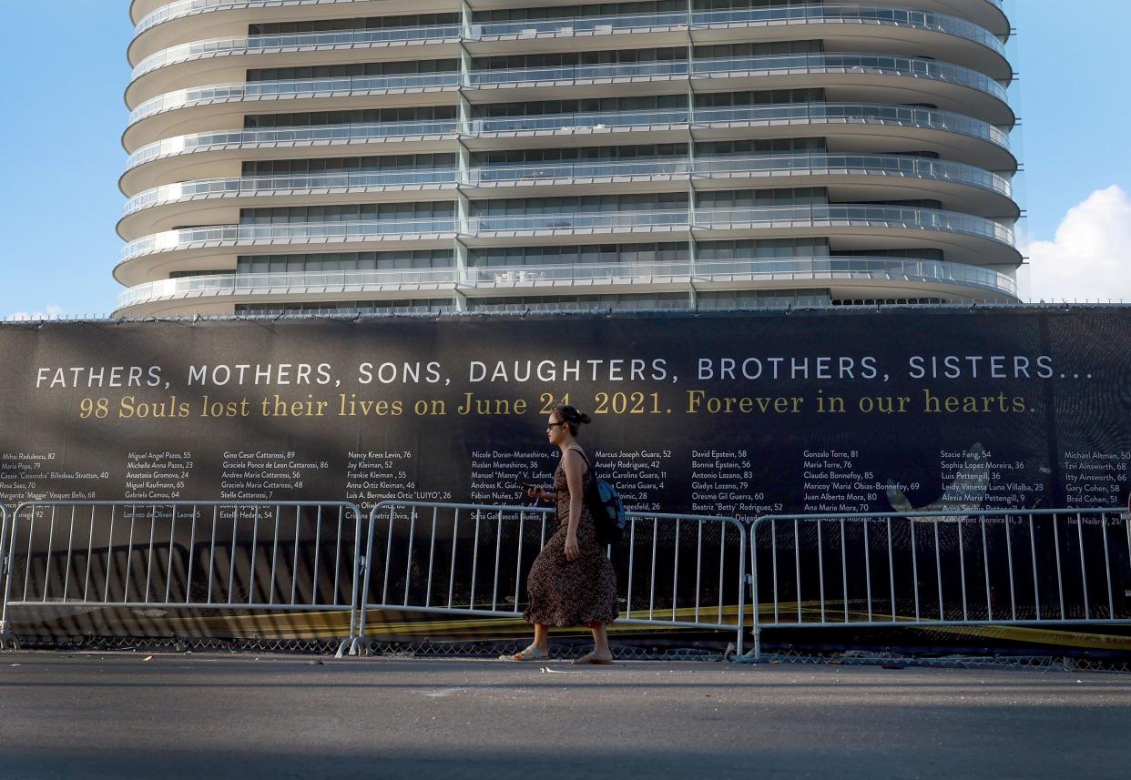 Names of the victims of the Champlain Towers South condo collapse are written on a screen surrounding the vacant lot where the 12-story building once stood on June 22, 2022 in Surfside, Fla.