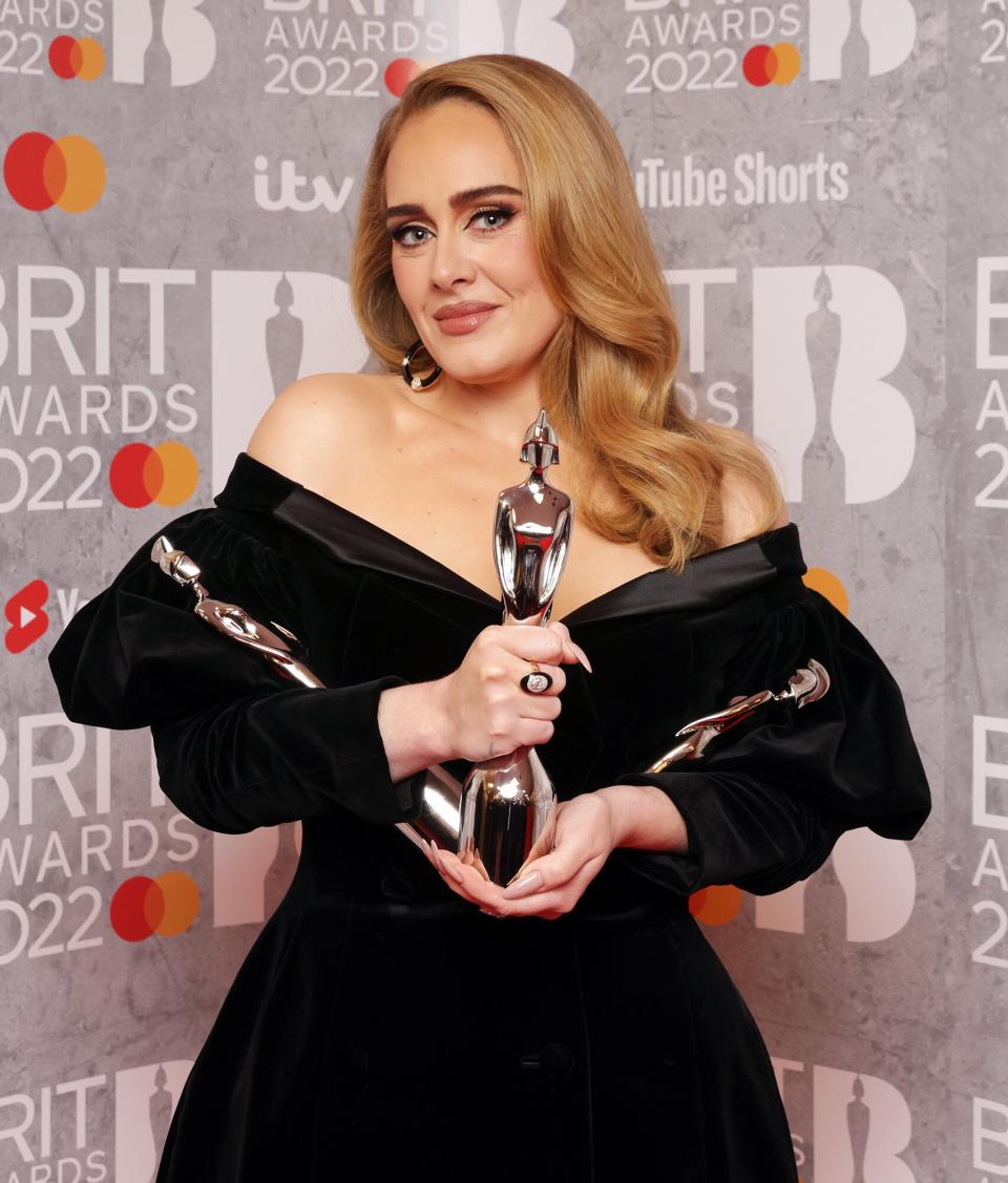 Adele poses with her awards for Song of the Year, Artist of the Year, and Album of the Year in the media room during The BRIT Awards 2022 at The O2 Arena on February 08, 2022 in London, England