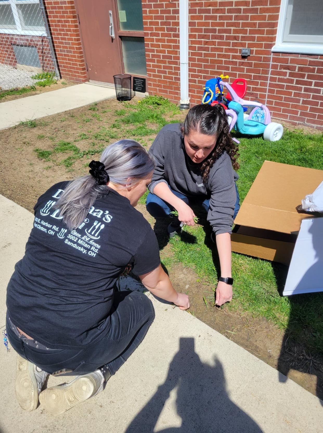 Members of the Ottawa County Specialized Docket program aid in cleaning up at Joyful Connections in Oak Harbor.