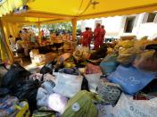 Volunteers and Red Cross workers prepare a temporary encampment for residents of earthquake affected areas in Amatrice