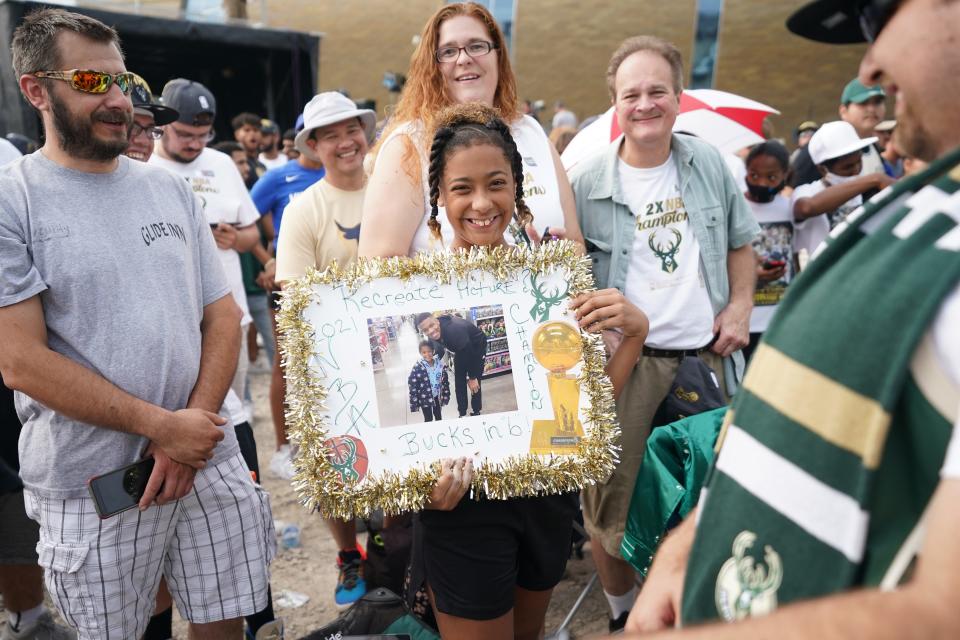 A fan holds a photo of herself with Giannis Antetokounmpo as part of the celebration of the Bucks' NBA championship in July 2021.