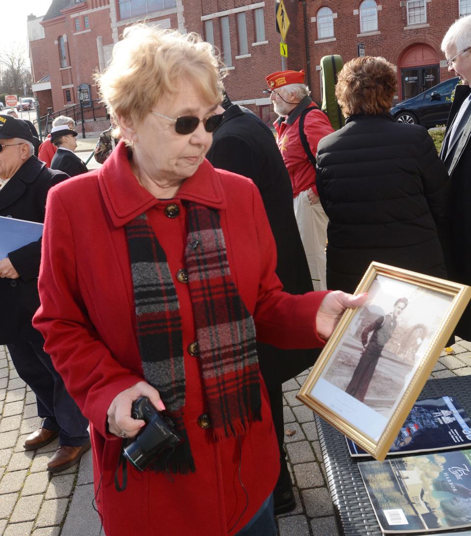 Rosalyn Lachapelle of Voluntown holds a photo of her uncle Harry Carlson, who died aboard the U.S.S. Arizona during the attack on Pearl Harbor 80 years ago Tuesday during Pearl Harbor Remembrance Day at Norwich City Hall.