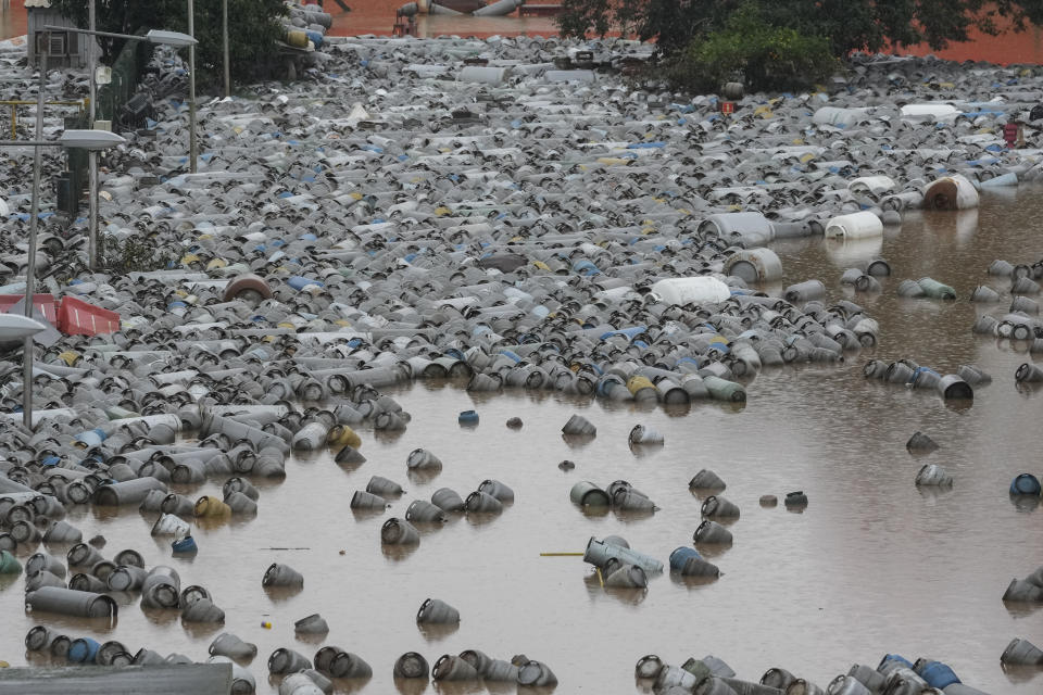 Gas cylinders are scattered outside a gas distribution center flooded by heavy rains, in Canoas, Rio Grande do Sul state, Brazil, Friday, May 10, 2024. (AP Photo/Andre Penner)